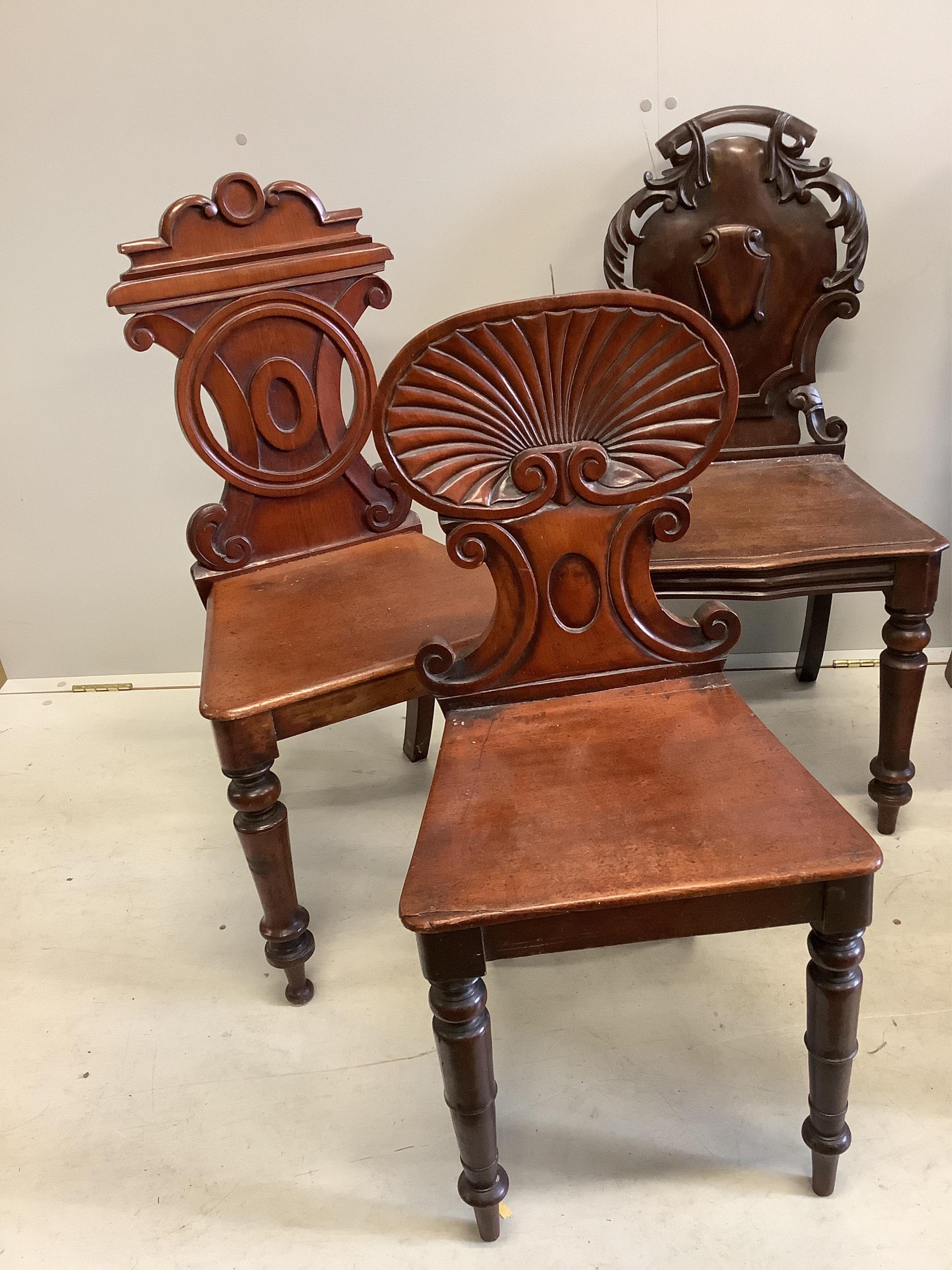 Seven George III and Victorian mahogany and oak hall chairs, largest height 95cm. Condition - fair to good